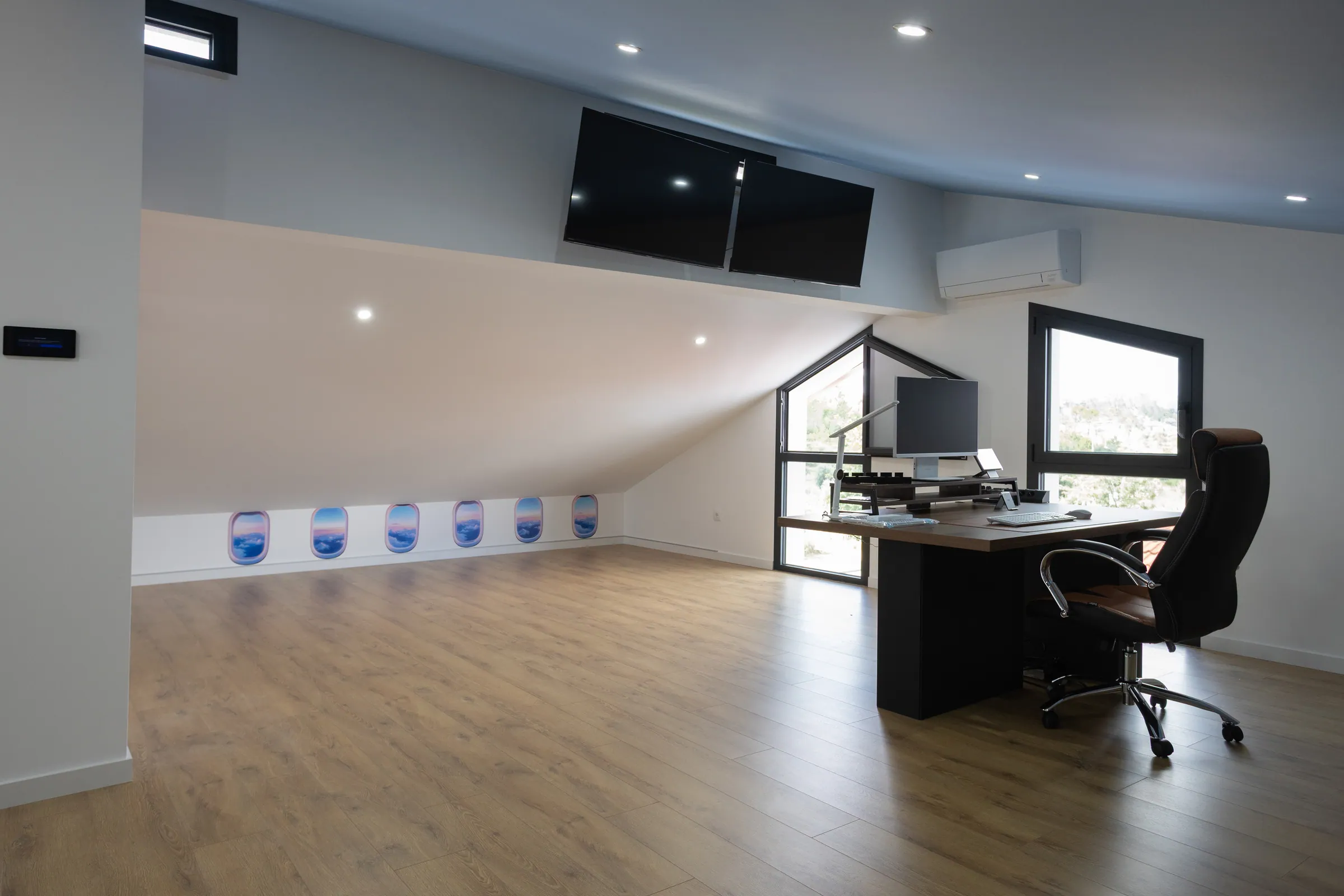 The attic office, with a desk under the sloping roof