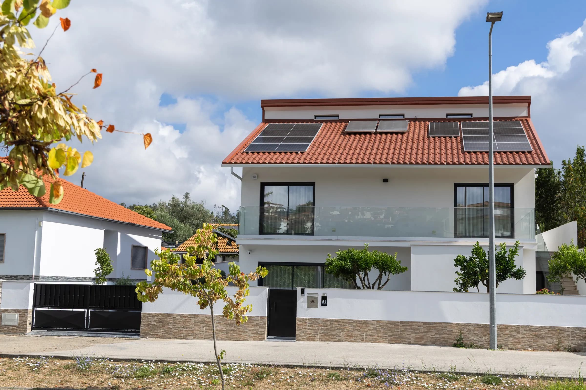 The villa from the road, with solar panels on the terracotta roof