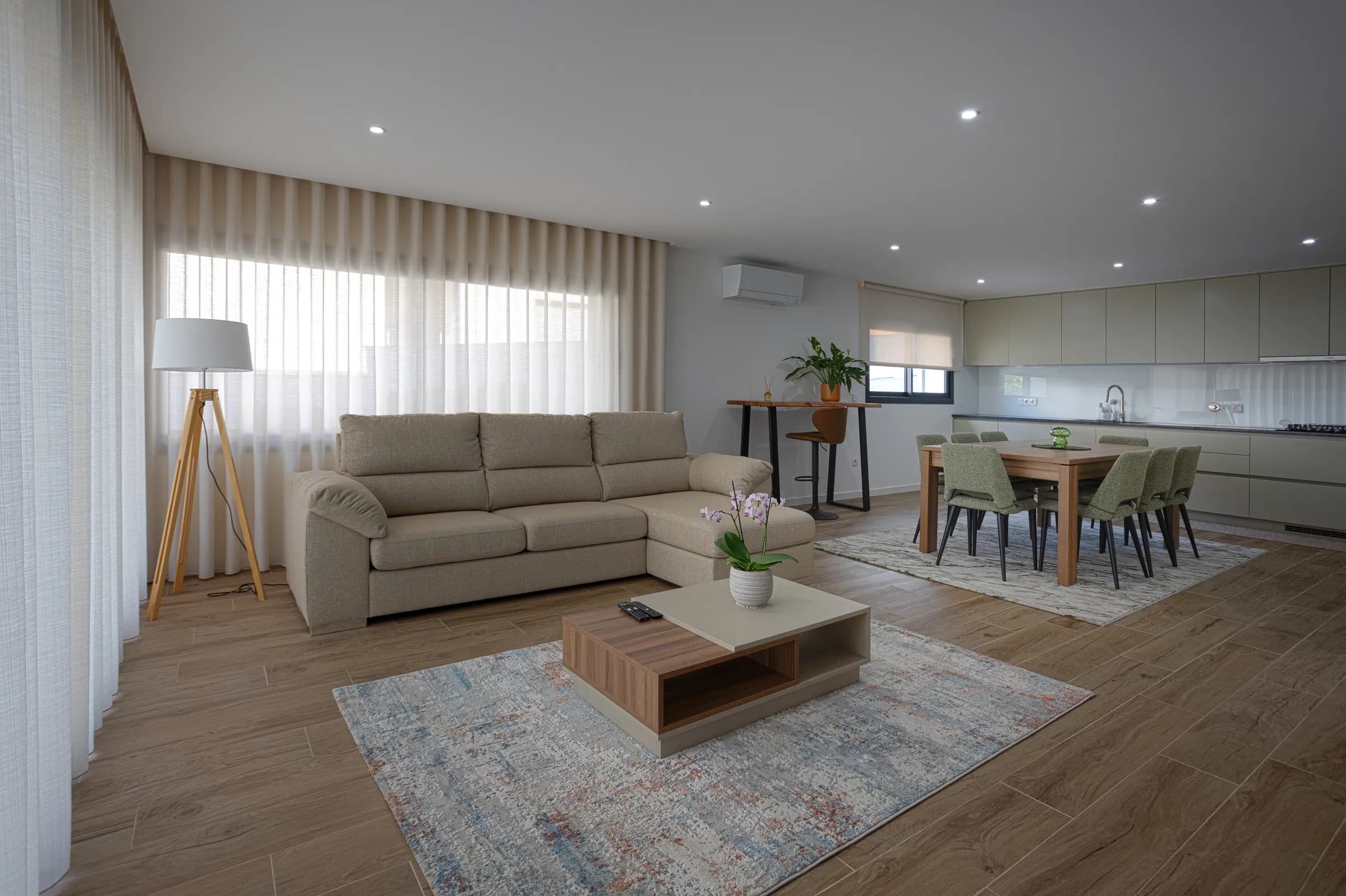 The living room with sofa, coffee table and dining area