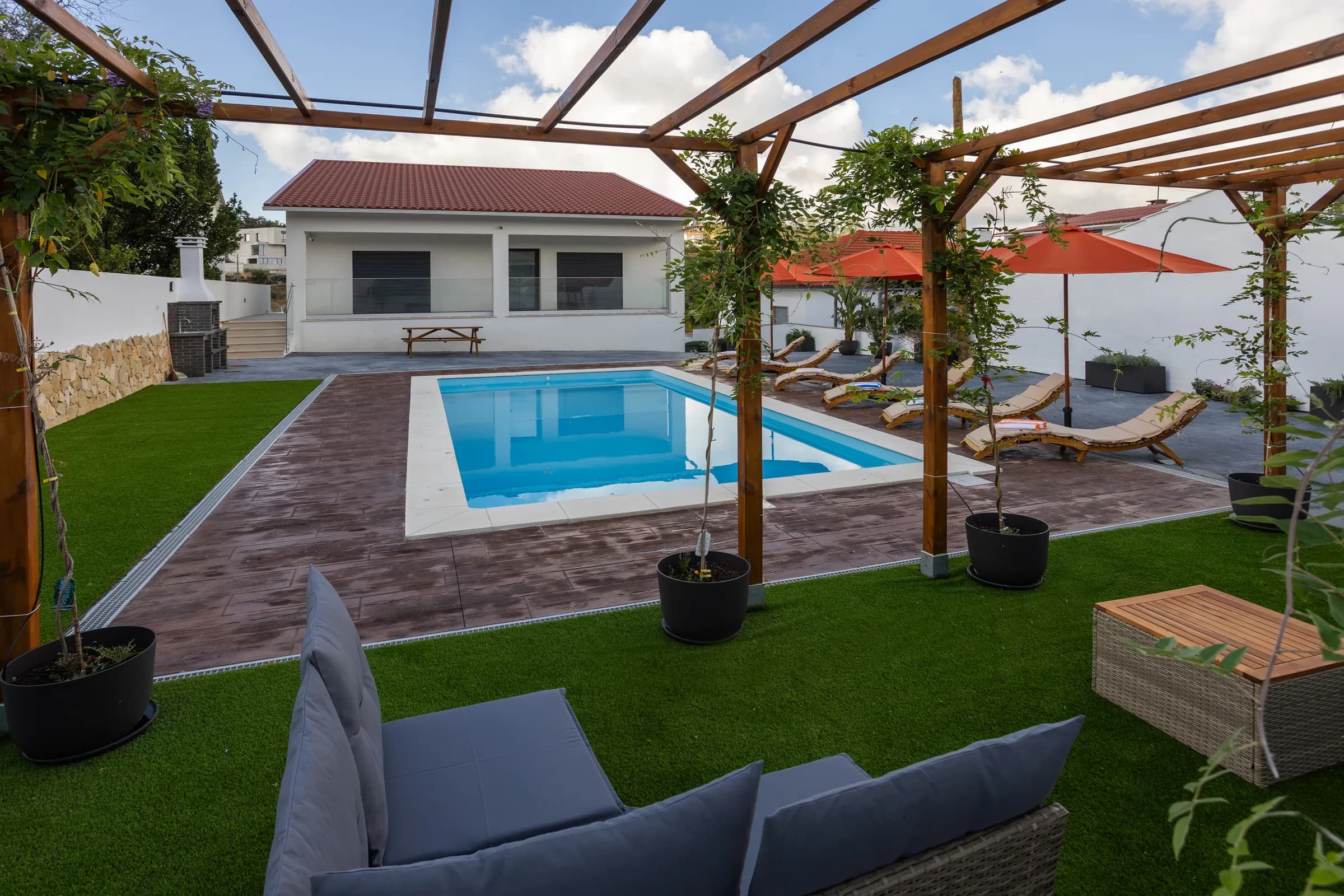 The pergola seating area looking across the pool to the villa