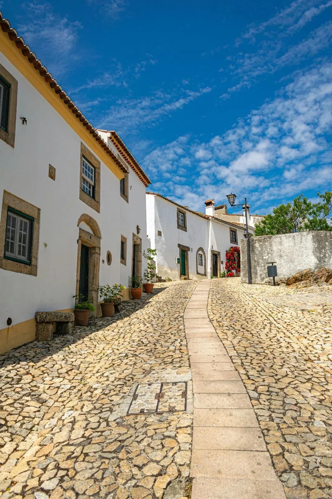 A cobbled street of whitewashed houses in a Portuguese village